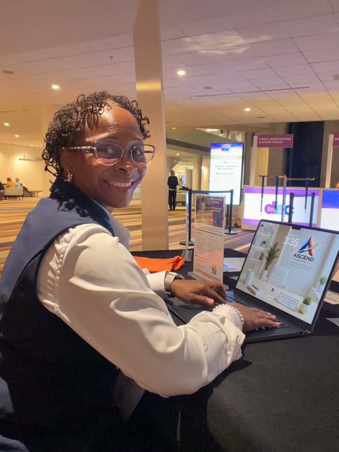Dr. Smith at a laptop showing Ascend AI NOW at DLAC Ignite